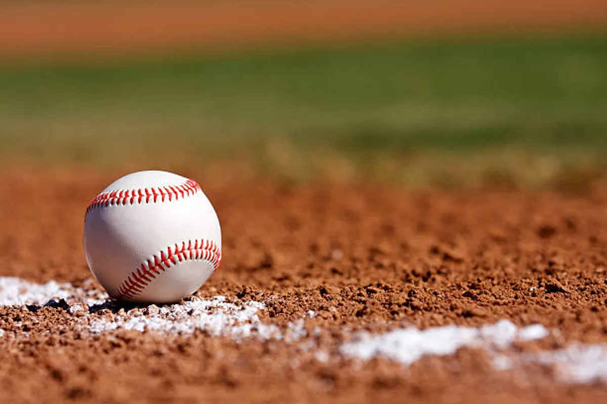 An exterior shot capturing a baseball diamond at Desert Breeze Park, with a clear view of the dirt infield, white chalk lines, and a baseball in play. The scene suggests recreational activities and community sports, inviting families to enjoy the outdoors together.